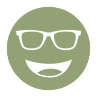 Circular icon with a smiling face wearing glasses in olive green, representing the Noir #12 lens tint.
