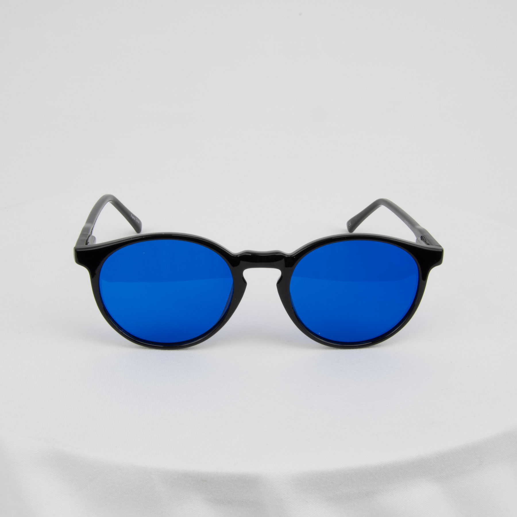 Round blue-tinted sunglasses on a white background.