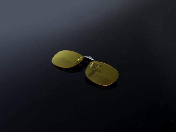 Custom flip-up clip-on for glasses with yellow/orange tinted lenses.