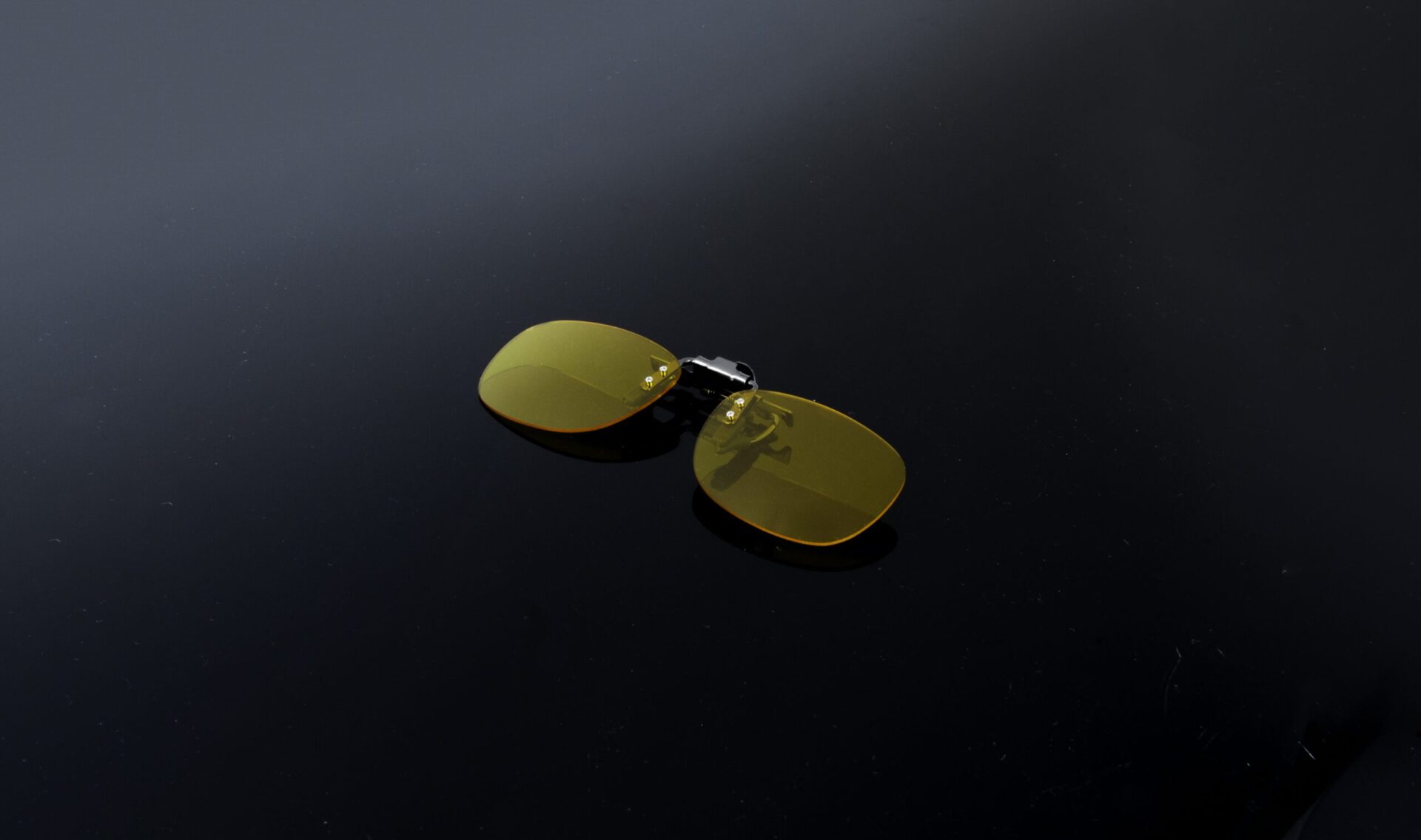 custom_clip_OV_Black_52-14_chadwick_optical Custom flip-up clip-on for glasses with yellow/orange tinted lenses.