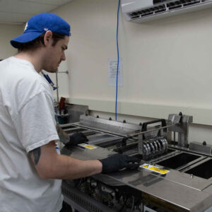 A Chadwick Optical staff member manages a the ultrasonic cleaning process.