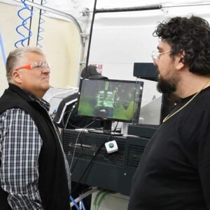 Ralf, wearing protective eyewear, talking in the lab