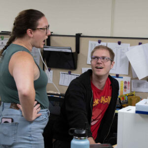 Michelle and John having an animated conversation at John's workstation in the Chadwick Optical office.