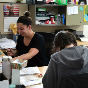 Faith and Jordan collaborating at their workstation at Chadwick Optical.