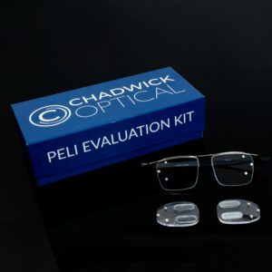 Chadwick Optical Peli Evaluation Kit box with glasses and specialized prism lenses, displayed on a black surface.