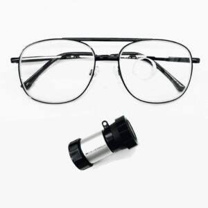 A pair of stylish eyeglasses alongside a small magnifier, showcasing eyewear and optical tools for vision enhancement.