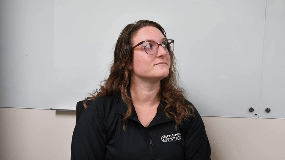 how_to_use_flippers_chadwick_optical Michelle from Chadwick Optical demonstrates the use of a flipper kit, looking upward thoughtfully during the process.