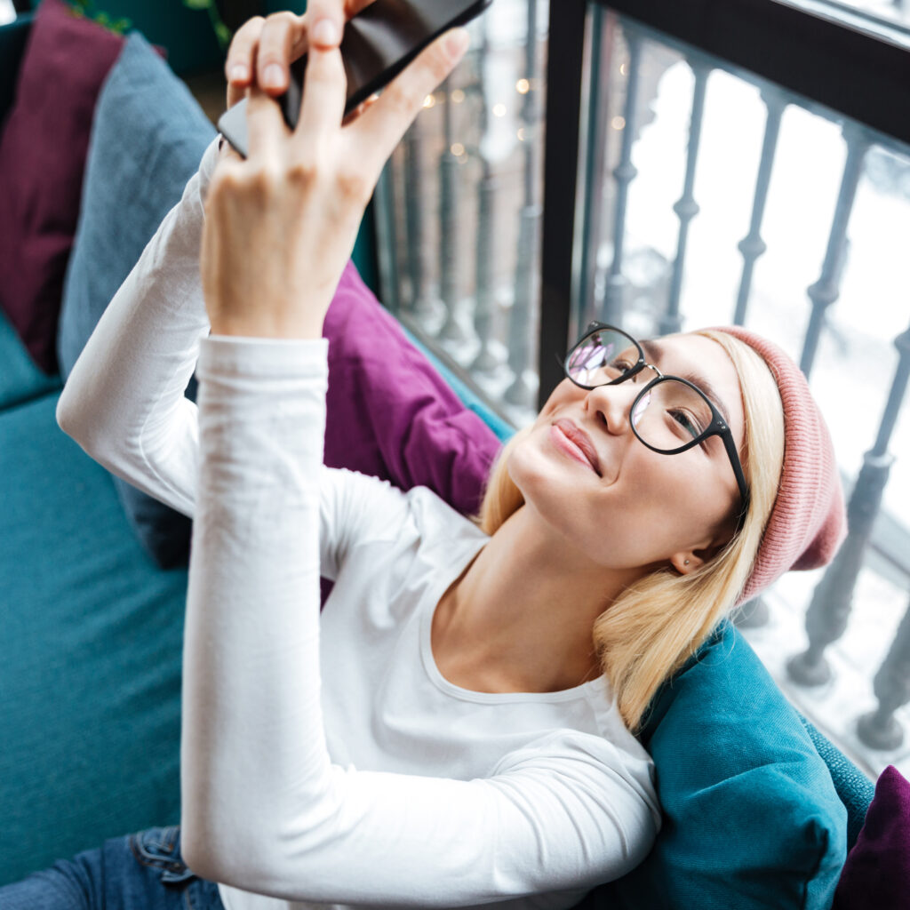 Shaw Lenses at Chadwick Optical SHAW™ Lenses from Chadwick Optical on a Young Woman looking at a phone