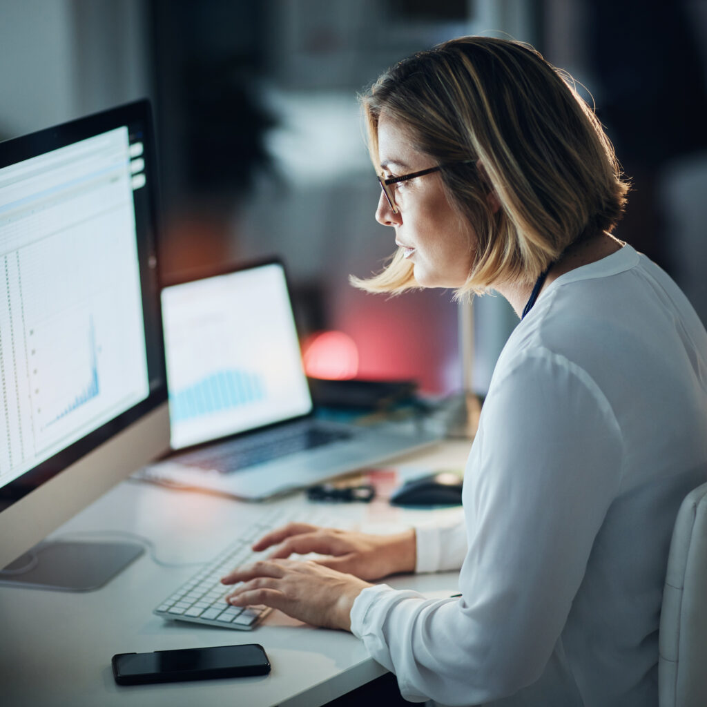 Computer,Screen,,Night,And,Business,Woman,With,Data,Analytics,,Spreadsheet Computer screen, night and business woman with data analytics, spreadsheet and statistics report for deadline. Tech analyst in office with graphs, charts and market research to monitor online growth