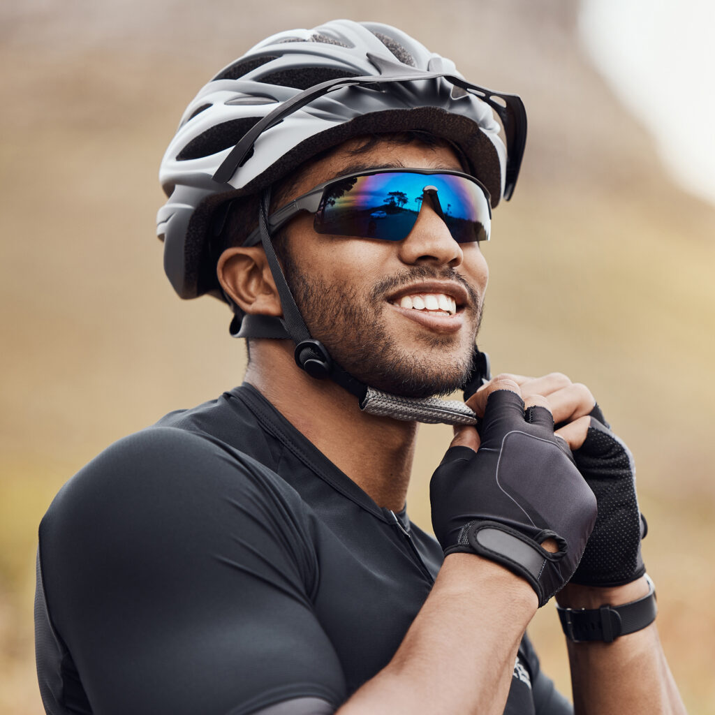 Male,Person,,Fitness,And,Cyclist,With,Helmet,,Sunglasses,And,Mountain Male person, fitness and cyclist with helmet, sunglasses and mountain road for sport, exercise and adventure. Man, safety and gloves as athlete in training, physical activity and wellness in nature