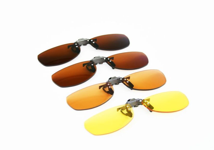 Four pairs of interchangeable sunglasses lenses in various colors
