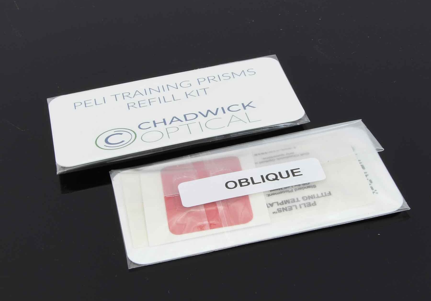 oblique-peli Close-up of a training prism refill kit labeled "Peli Training Prisms Refill Kit, Chadwick Optical," with a package marked "Oblique" on a black surface.