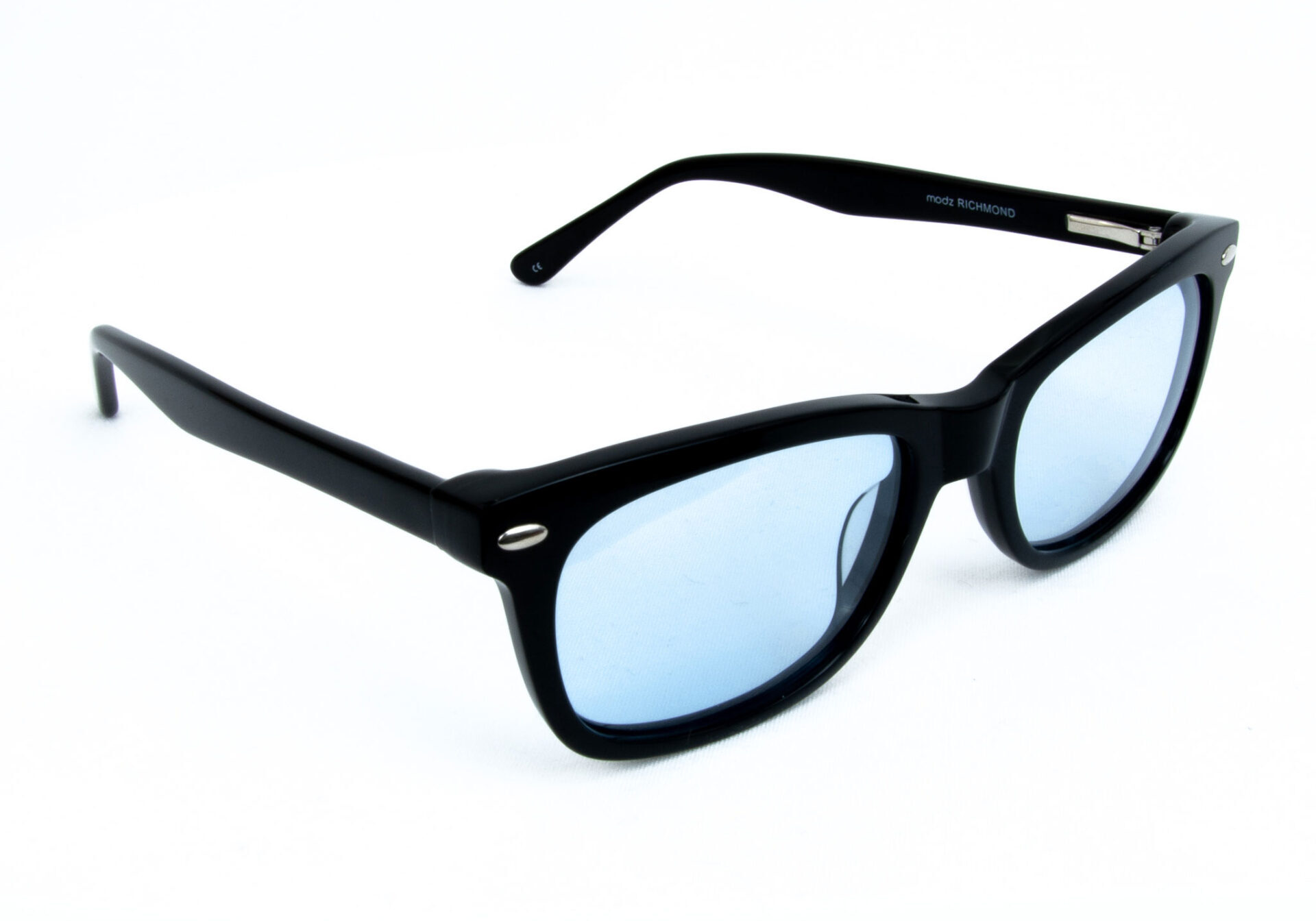 Black sunglasses with blue-tinted lenses, angled on a white background, designed for calming light sensitivity.